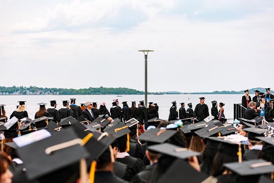 Graduates at 2024 commencement by the water