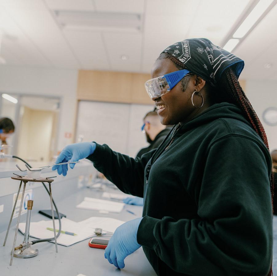 Student using the bunsen burner is science lab